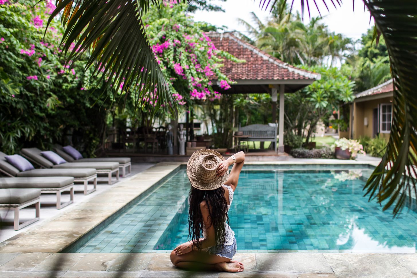 young-slim-woman-relaxing-near-pool-with-straw-hat-2021-09-01-01-20-04-utc